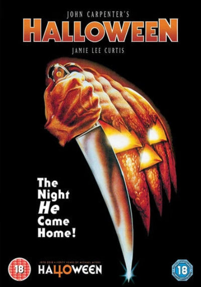 Movie poster for 'Halloween' featuring a hand holding a knife with a carved pumpkin.