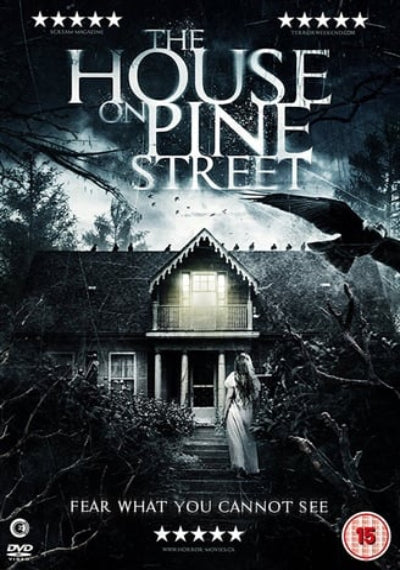 Movie poster for 'The House on Pine Street' with a woman walking towards a house in the woods.