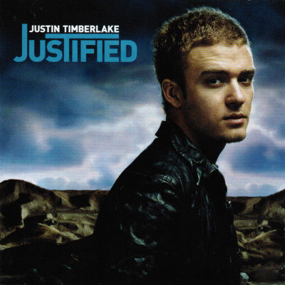 Album cover with a person against a desert landscape, featuring the text 'Justin Timberlake Justified'.