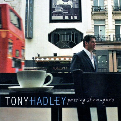 Album cover with a man, coffee cup, and London bus, featuring 'Tony Hadley Passing Strangers'.
