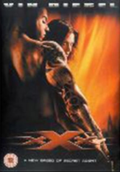 Movie poster for 'xXx' with two people embracing against a warm glow
