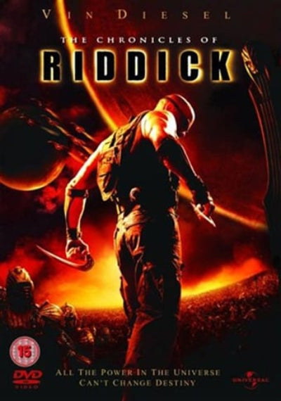 The front cover of the DVD release for 'The Chronicles of Riddick' featuring Vin Diesel in a dark suit against a fiery orange and red sci-fi background with planets and dramatic title text.