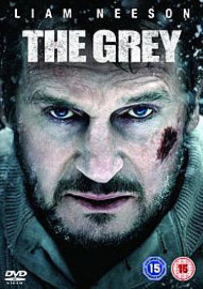Poster of 'The Grey' featuring Liam Neeson with a close-up of his face.