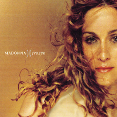 Album cover with a close-up of a person with flowing hair and the text 'Madonna Frozen' on a gold background.