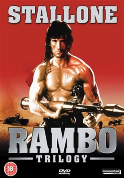 DVD cover for 'Stallone Rambo Trilogy' featuring Sylvester Stallone as Rambo holding a minigun against a red gradient background, with the title 'RAMBO TRILOGY' in large silver letters and a DVD logo at the bottom.
