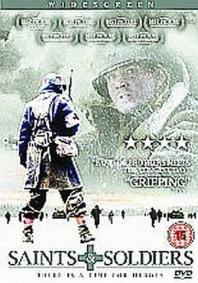 DVD cover for the film 'Saints and Soldiers' featuring a soldier in a blue winter coat walking through snow, a large faded face in the background, and the title at the bottom.