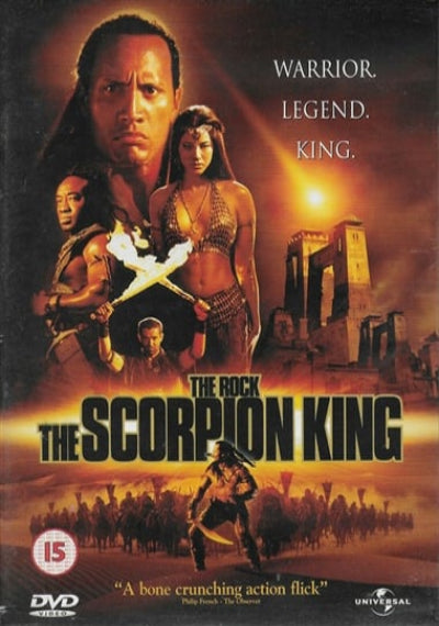 The front cover of the DVD release for the movie 'The Rock: The Scorpion King'. The artwork features a dramatic desert scene with a fiery sunset, ancient stone structures, and a warrior silhouette.
