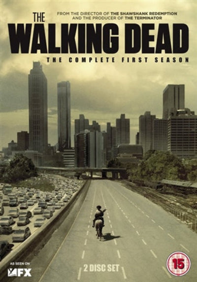 DVD cover of 'The Walking Dead' complete first season with a cityscape and lone figure on a road.